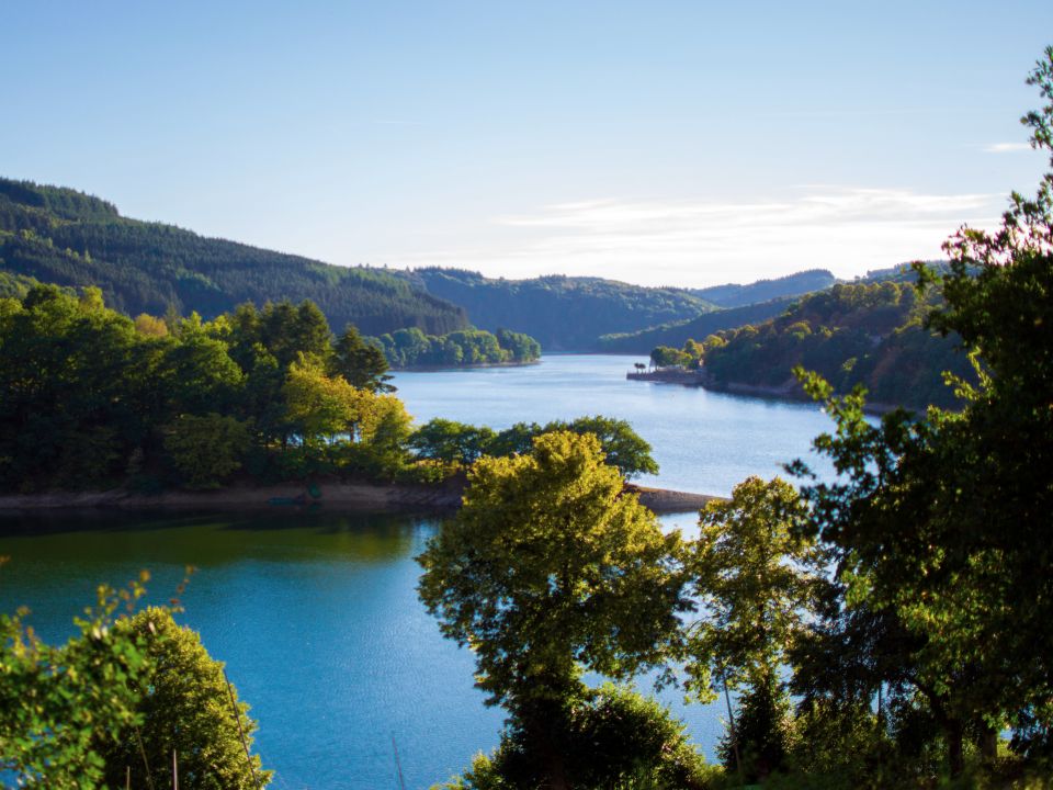Sure river in Lultzhausen, Esch-sur-Sure, Luxembourg. Beautiful landscape with green mountains at the both sides
