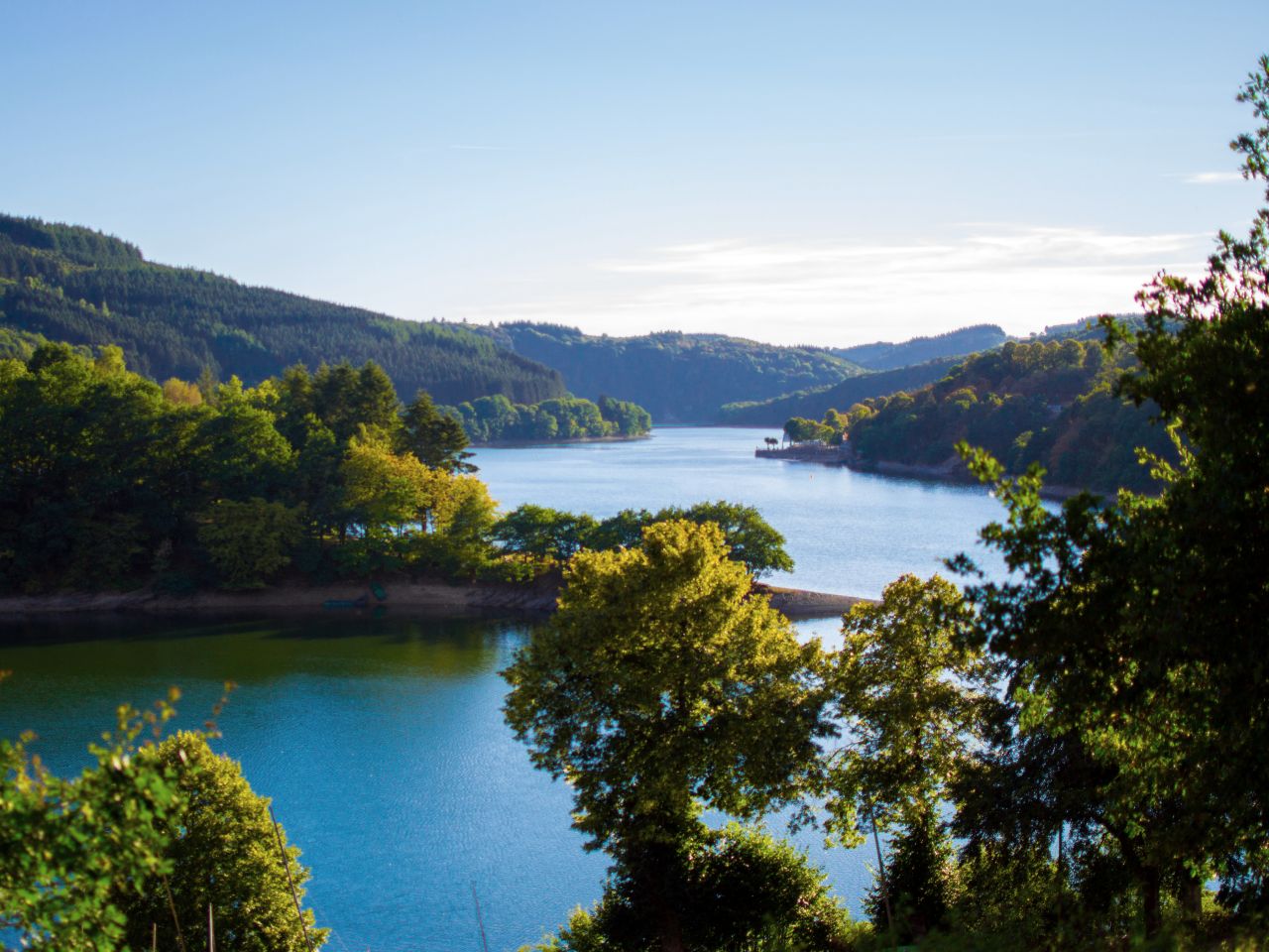 Sure river in Lultzhausen, Esch-sur-Sure, Luxembourg. Beautiful landscape with green mountains at the both sides
